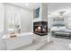 Luxurious main bedroom showcases a freestanding tub, a fireplace and a comfortable bed with stylish decor at 375 Wellington Ave, Oldsmar, FL 34677