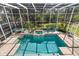 An indoor pool with spa, surrounded by lush greenery and palm trees at 375 Wellington Ave, Oldsmar, FL 34677