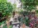 Charming backyard with lush greenery, a small table, and a wrought-iron fence at 418 S Habana Ave, Tampa, FL 33609