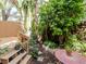 Secluded backyard retreat with a lush garden, patio area, and decorative plants at 418 S Habana Ave, Tampa, FL 33609