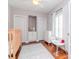 Brightly lit bedroom with hardwood floors, white trim, two closets, and a ceiling fan at 418 S Habana Ave, Tampa, FL 33609
