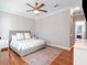 Comfortable bedroom with hardwood floors, a cozy queen-sized bed, and soft, neutral colors at 418 S Habana Ave, Tampa, FL 33609