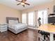 Comfortable bedroom with dark wood floors, a cozy bed, and plenty of natural light at 418 S Habana Ave, Tampa, FL 33609