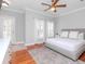 Bright bedroom with hardwood floors, a cozy queen-sized bed, and soft, neutral colors at 418 S Habana Ave, Tampa, FL 33609