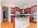 Gourmet kitchen with custom wood cabinets, a stainless steel refrigerator, and recessed lighting at 418 S Habana Ave, Tampa, FL 33609