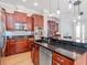 Spacious kitchen featuring custom wood cabinets, granite countertops, and stainless steel appliances at 418 S Habana Ave, Tampa, FL 33609