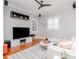 Contemporary living room with hardwood floors, a modern TV, and stylish window shutters at 418 S Habana Ave, Tampa, FL 33609