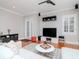 Bright living room with hardwood floors, modern furniture, and large windows for natural light at 418 S Habana Ave, Tampa, FL 33609