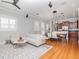 Bright living room with hardwood floors, a modern sofa, and an open concept design at 418 S Habana Ave, Tampa, FL 33609