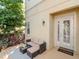 Cozy outdoor patio with a stylish seating area and lush landscaping at 418 S Habana Ave, Tampa, FL 33609