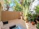Relaxing backyard deck featuring a comfortable sofa, glass table, and privacy fence at 418 S Habana Ave, Tampa, FL 33609