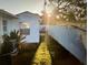 Fenced backyard with a grassy strip and patio set at 425 Highland Ct, Dunedin, FL 34698
