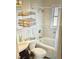 Well-lit bathroom featuring a shower-tub combination and tiled walls at 425 Highland Ct, Dunedin, FL 34698