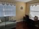 Bright office features two windows, a work desk, and comfortable seating for a productive workspace at 425 Highland Ct, Dunedin, FL 34698