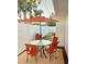 Outdoor patio featuring a round table, chairs, and a red umbrella at 425 Highland Ct, Dunedin, FL 34698