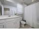 Bathroom featuring white cabinetry, a large mirror, and a shower with white tiling at 4272 Cloud Hopper Way, Lutz, FL 33559