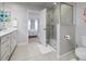 Bright bathroom features a tiled shower and vanity with adjacent bedroom at 4272 Cloud Hopper Way, Lutz, FL 33559