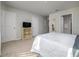 Bedroom with tv, carpet, and neutral colored walls and accents at 4272 Cloud Hopper Way, Lutz, FL 33559