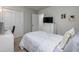 Cozy bedroom features a white dresser, tv, and plush carpet at 4272 Cloud Hopper Way, Lutz, FL 33559