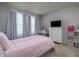 Comfortable bedroom features a large window and natural light, and modern furniture at 4272 Cloud Hopper Way, Lutz, FL 33559