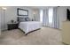 Bedroom featuring a large window, carpet floor, and a comfy bed at 4272 Cloud Hopper Way, Lutz, FL 33559