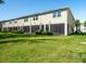 Back exterior of home with multiple sliding glass doors leading to outdoor living spaces at 4272 Cloud Hopper Way, Lutz, FL 33559