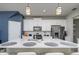 Spacious kitchen featuring an island, white cabinetry, stainless steel appliances, and stylish backsplash at 4272 Cloud Hopper Way, Lutz, FL 33559