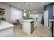 Modern kitchen featuring an island with bar seating and stainless steel dishwasher at 4272 Cloud Hopper Way, Lutz, FL 33559