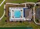 Overhead view of community pool featuring a splashpad, lounge seating, and lake views at 4272 Cloud Hopper Way, Lutz, FL 33559