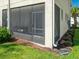 Screened patio on home with grass in the back and landscaping at 4272 Cloud Hopper Way, Lutz, FL 33559