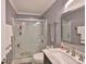 Bathroom featuring a white vanity, large mirror, and shower with a glass door at 4315 Aegean Dr # 130C, Tampa, FL 33611