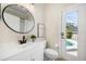 Clean, bright bathroom with sleek fixtures and a view of the sparkling pool area at 434 Arch Ridge Loop # 434, Seffner, FL 33584