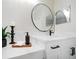 Stylish bathroom featuring modern fixtures, elegant vanity with round mirror, and sophisticated design at 434 Arch Ridge Loop # 434, Seffner, FL 33584