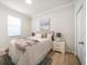 Comfortable bedroom featuring a cozy bed, natural light, and minimalist decor for a serene ambiance at 434 Arch Ridge Loop # 434, Seffner, FL 33584
