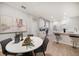 Bright eat-in kitchen boasts white countertops and cabinets with gray accent chairs by modern art at 434 Arch Ridge Loop # 434, Seffner, FL 33584