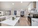 Well-lit kitchen with stainless steel appliances, quartz countertops, and adjacent dining area at 434 Arch Ridge Loop # 434, Seffner, FL 33584