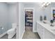 Bright bathroom with a toilet, and double sink vanity with an open walk-in closet at 436 12Th Ne Ave, St Petersburg, FL 33701