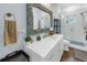 Elegant bathroom features a marble countertop, decorative mirror, and a glass-enclosed walk-in shower at 436 12Th Ne Ave, St Petersburg, FL 33701