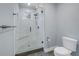 Modern bathroom with a glass-enclosed shower and white tiled walls at 436 12Th Ne Ave, St Petersburg, FL 33701