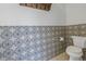 Charming powder room featuring patterned tile accent wall and neutral flooring at 436 12Th Ne Ave, St Petersburg, FL 33701