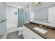 Bathroom features a tub and shower combination, white vanity with gray countertop and blue walls at 436 12Th Ne Ave, St Petersburg, FL 33701