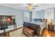 Bright bedroom with a ceiling fan, two windows, a dark sleigh bed and a dark wood desk at 436 12Th Ne Ave, St Petersburg, FL 33701