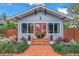 Home featuring a brick walkway, complemented by green shrubbery, leading to a vibrant red front door at 436 12Th Ne Ave, St Petersburg, FL 33701