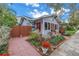 Charming exterior view showcasing the home's manicured garden, brick walkway, and cozy curb appeal at 436 12Th Ne Ave, St Petersburg, FL 33701