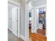 Hallway with hardwood floors leads to a pantry, bathroom and bedroom in this well-maintained home at 436 12Th Ne Ave, St Petersburg, FL 33701