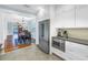 Bright kitchen featuring stainless steel appliances, white cabinetry, and an adjacent dining area at 436 12Th Ne Ave, St Petersburg, FL 33701