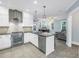 Modern kitchen with stainless steel appliances, white cabinets, and an island open to the living area at 436 12Th Ne Ave, St Petersburg, FL 33701