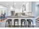 Stylish kitchen island with dark countertops, seating for four, and stainless steel appliances at 436 12Th Ne Ave, St Petersburg, FL 33701
