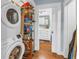 Easy access to laundry room and bathroom with white doorframes and hardwood flooring at 436 12Th Ne Ave, St Petersburg, FL 33701