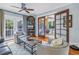 Cozy living room with hardwood floors, a ceiling fan and access to another room through glass doors at 436 12Th Ne Ave, St Petersburg, FL 33701